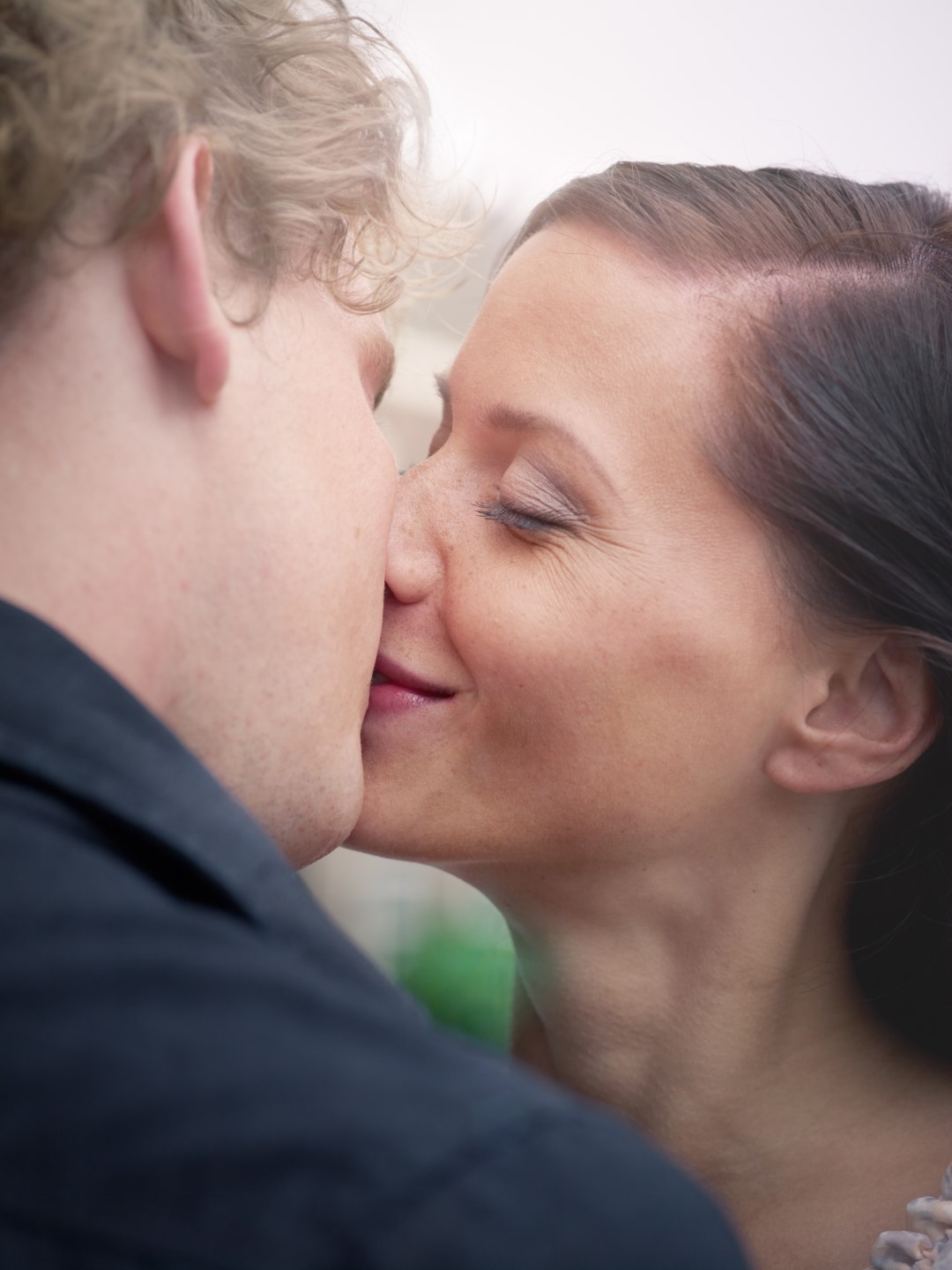 man and woman kissing and smiling during intimacy after a support group